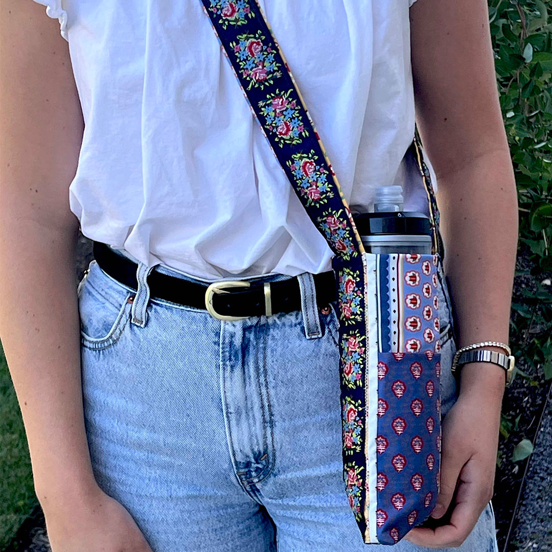 Woman with water bottle holder across body