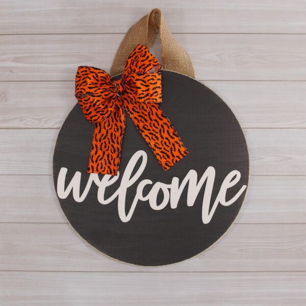 Welcome sign hanging with orange ribbon