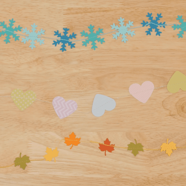 Variety of seasonal garlands on wood background