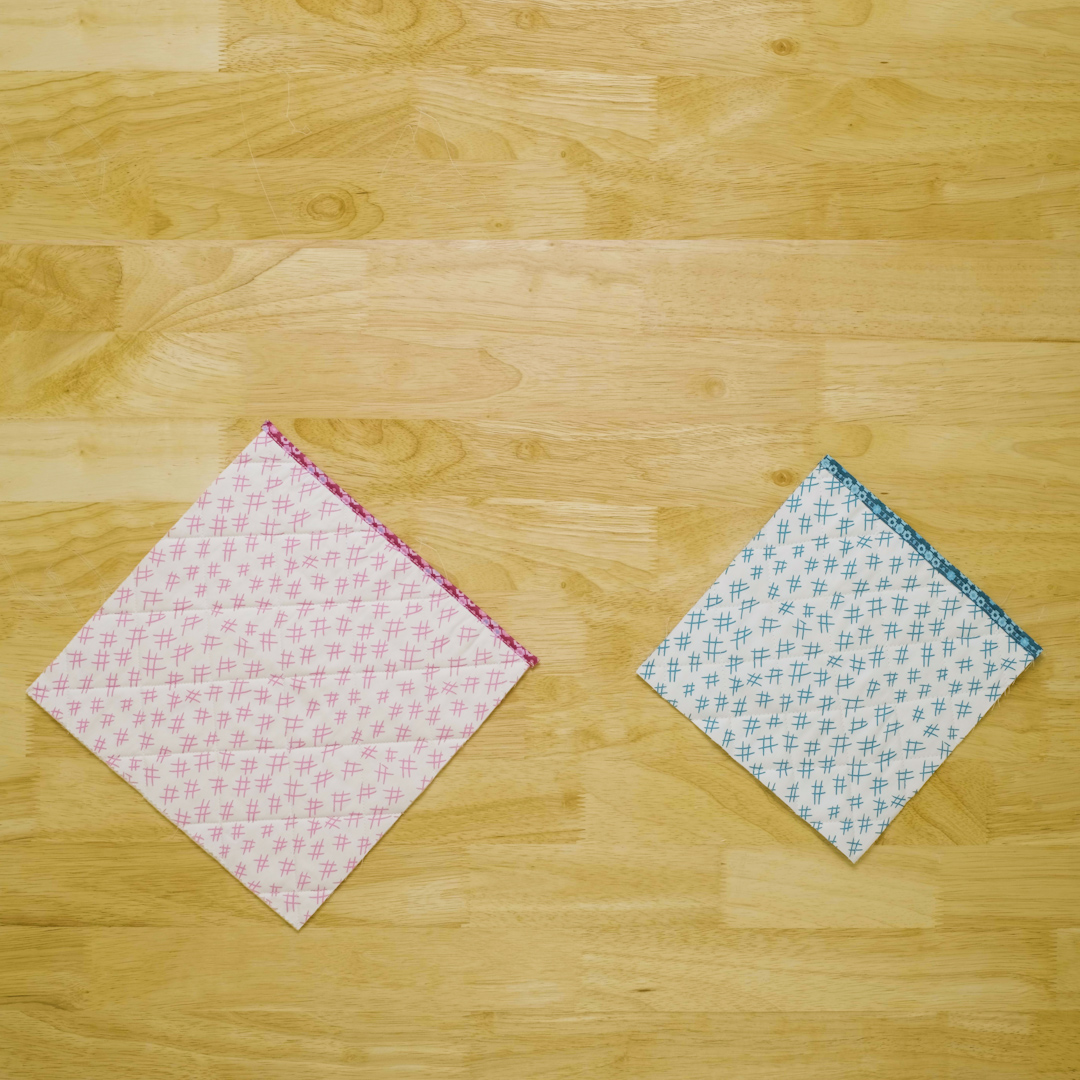 Overhead view of two fabric samples with binding