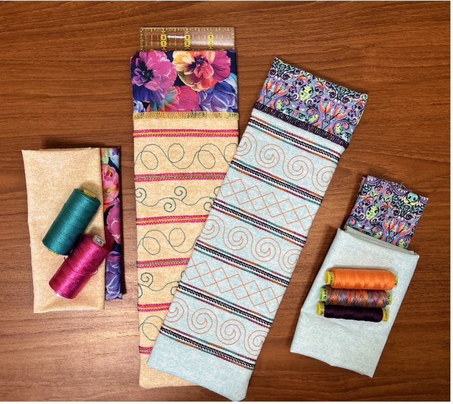 Finished Ruler Sleeves arranged on a table with various threads