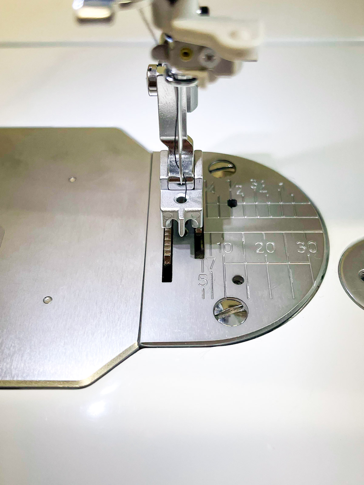 Invisible Zipper Foot Setup on the machine showing the grooves where the zipper teeth are inserted for stitching