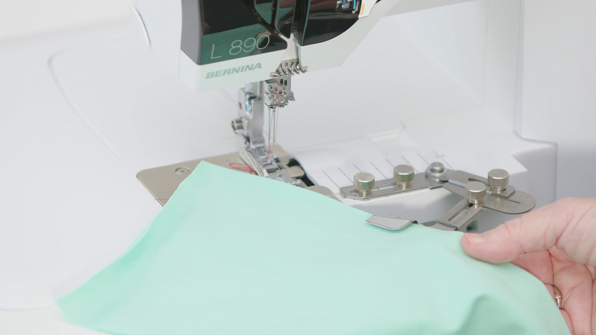 foam green fabric in front of a serger machine