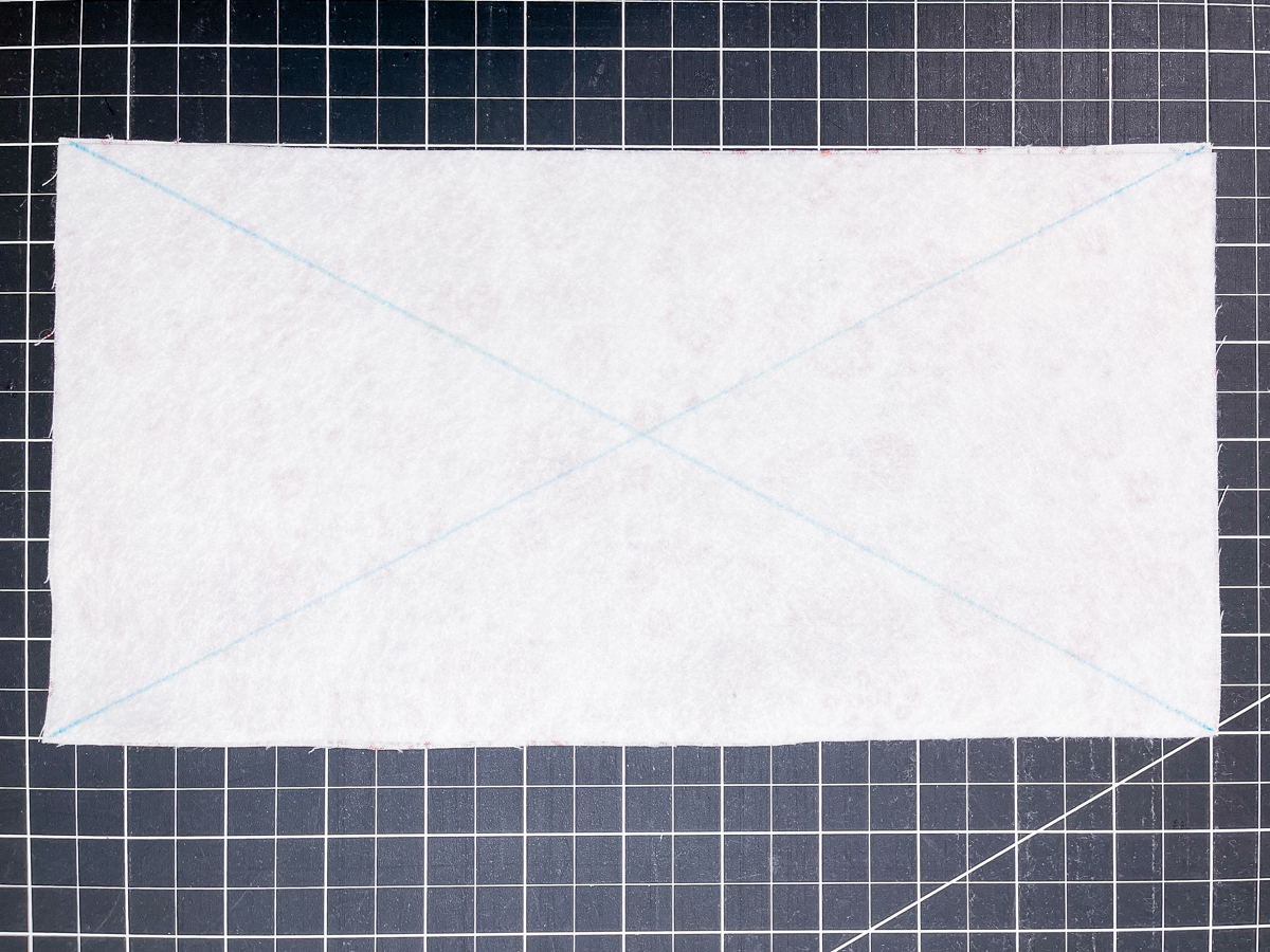 white fleece marked with two blue lines diagonally