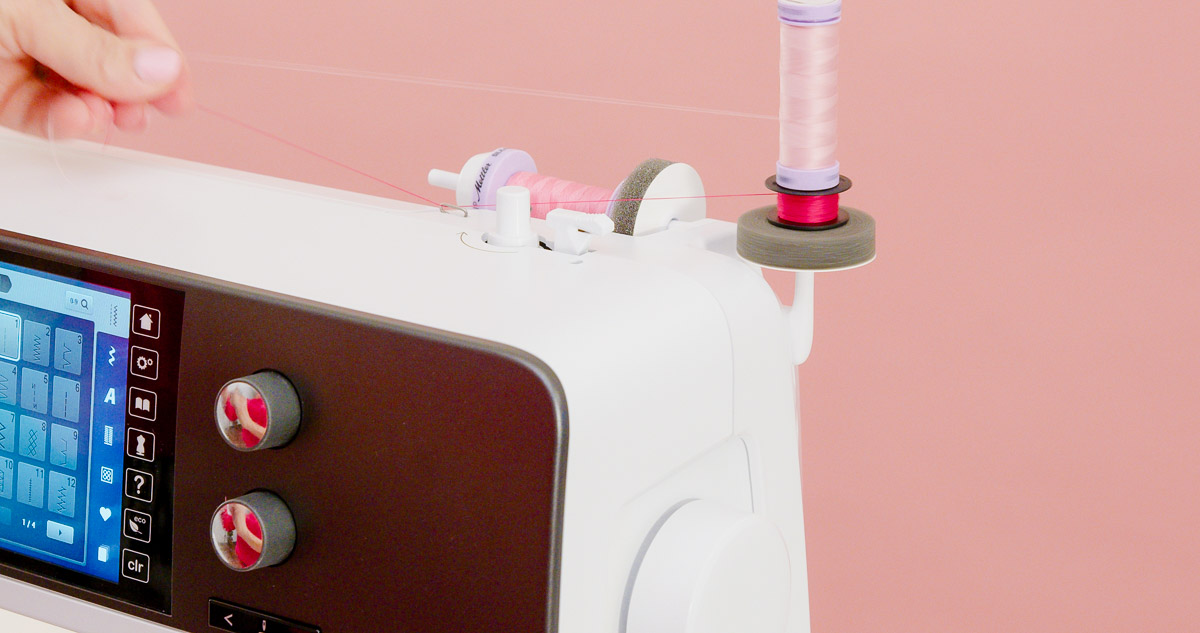 Two spools and one bobbin on spool holders