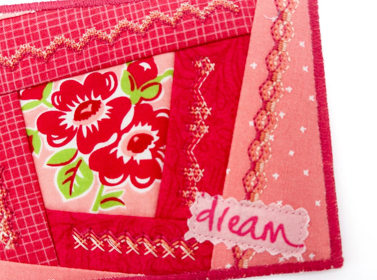 Close-up of fabric postcard with dream