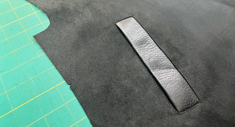 A close up image of a single welt pocket made in leather.