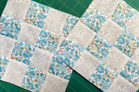 Two 16-patch quilt blocks layered on top of each other.