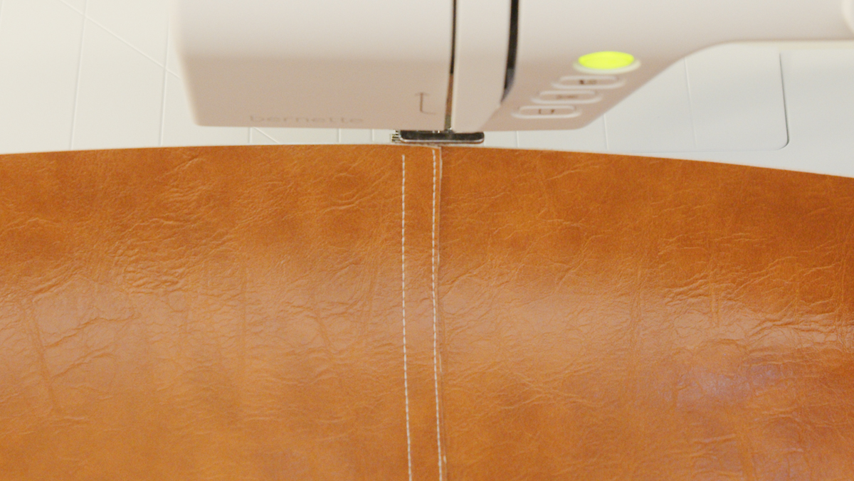 Overhead view of a lap seam on brown leather.