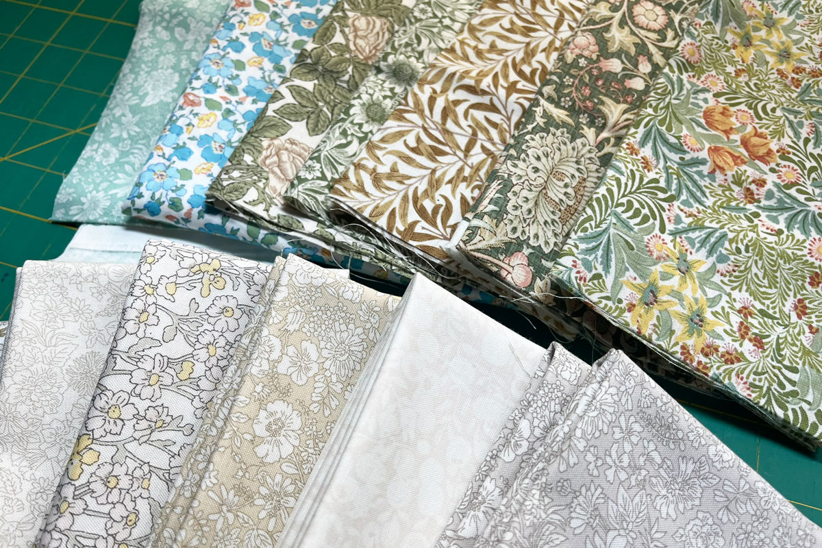 Two fat quarter bundles. One bundle is shades of greens and blues, the second is neutrals.