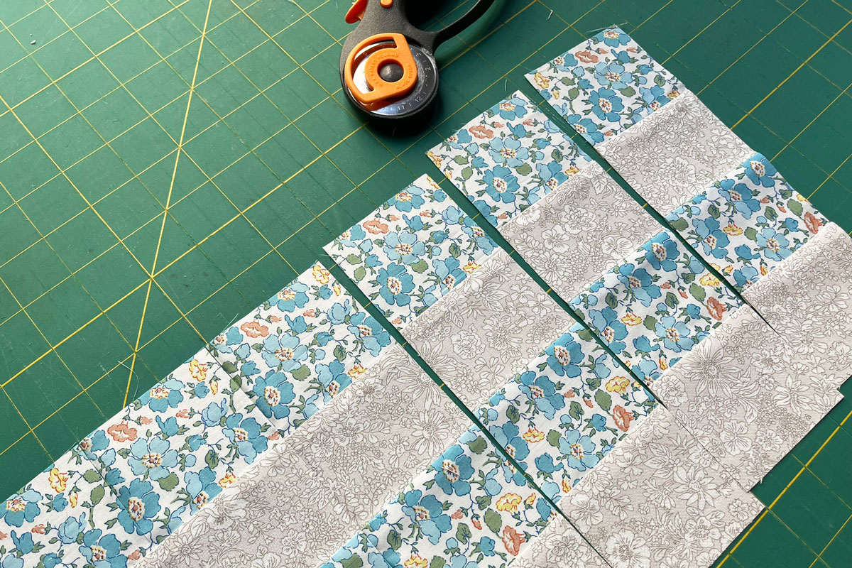 An image depicting strip piecing cut into vertical columns to form the rows for a 16-patch quilt block.