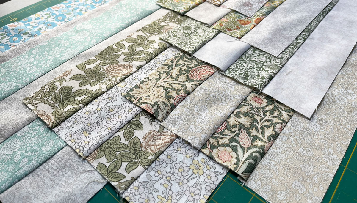 Batches of 4-strip strip pieced sets awaiting cutting for a 16-patch block.