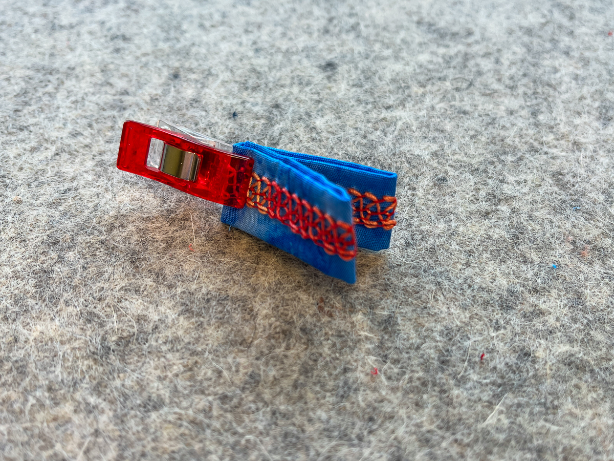 Finger-press and place a clip at the half-fold