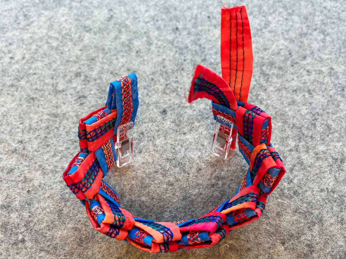 form a circle with the blue and orange folded pieces