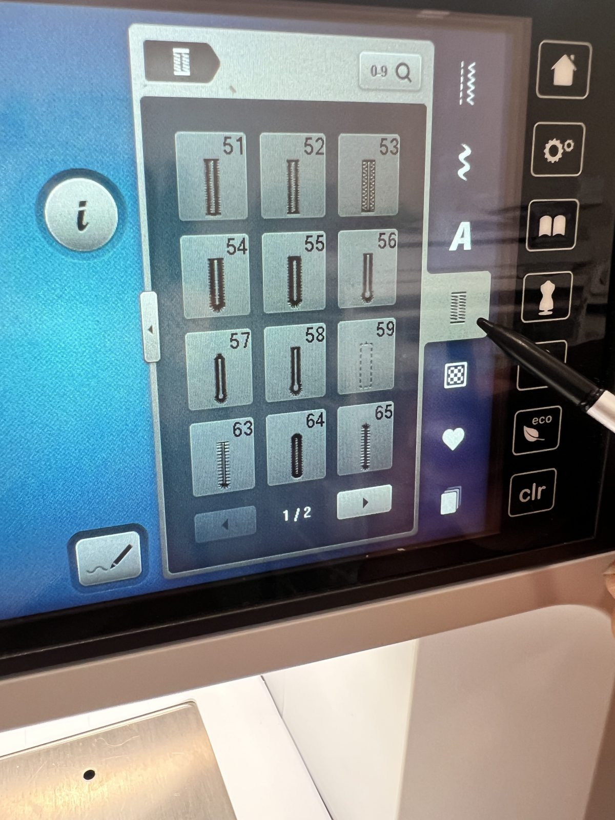 Close up of the BERNINA sewing machine touchscreen showing various buttonhole stitch options, with a stylus pointing to the buttonhole menu