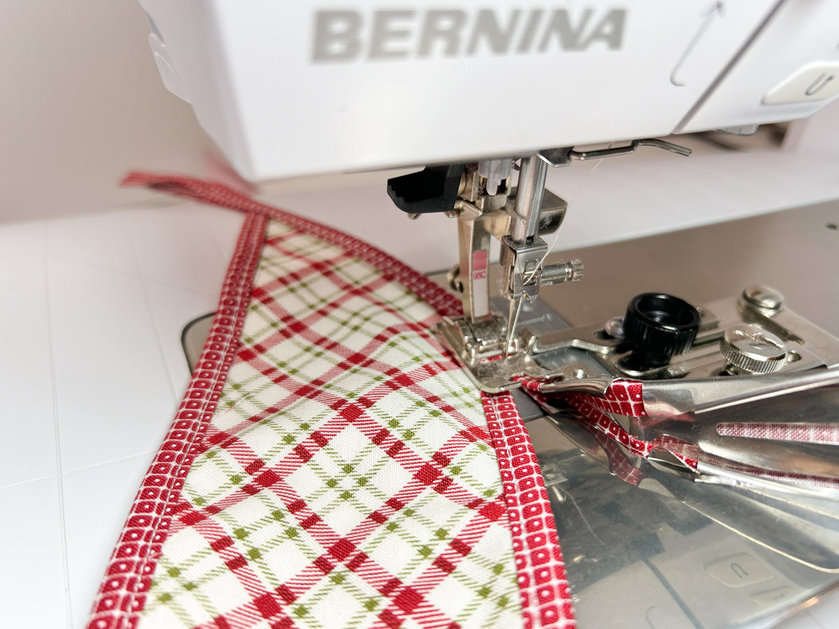 close up view showing how to stitch past the end of the fabric.