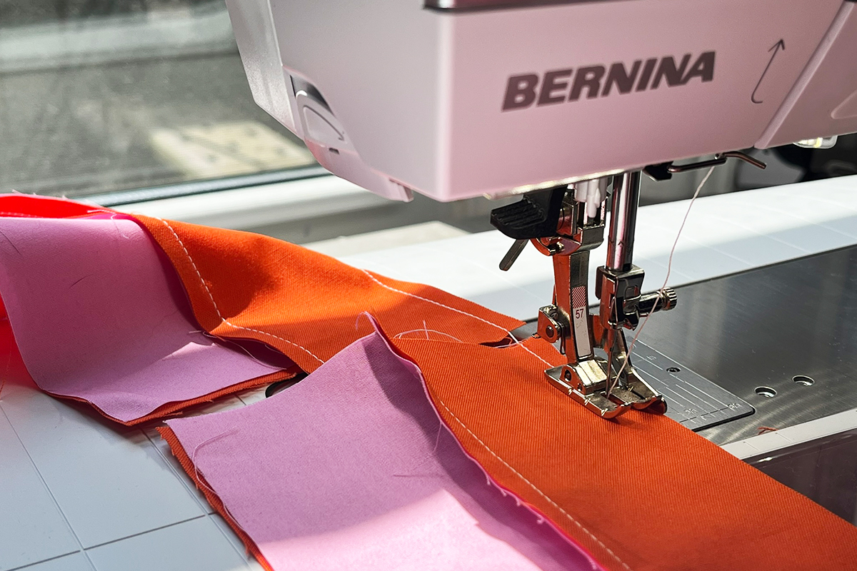 Patchwork Foot with Guide #57 on the B 735. Orange and pink fabrics are being sewn for a quilt.