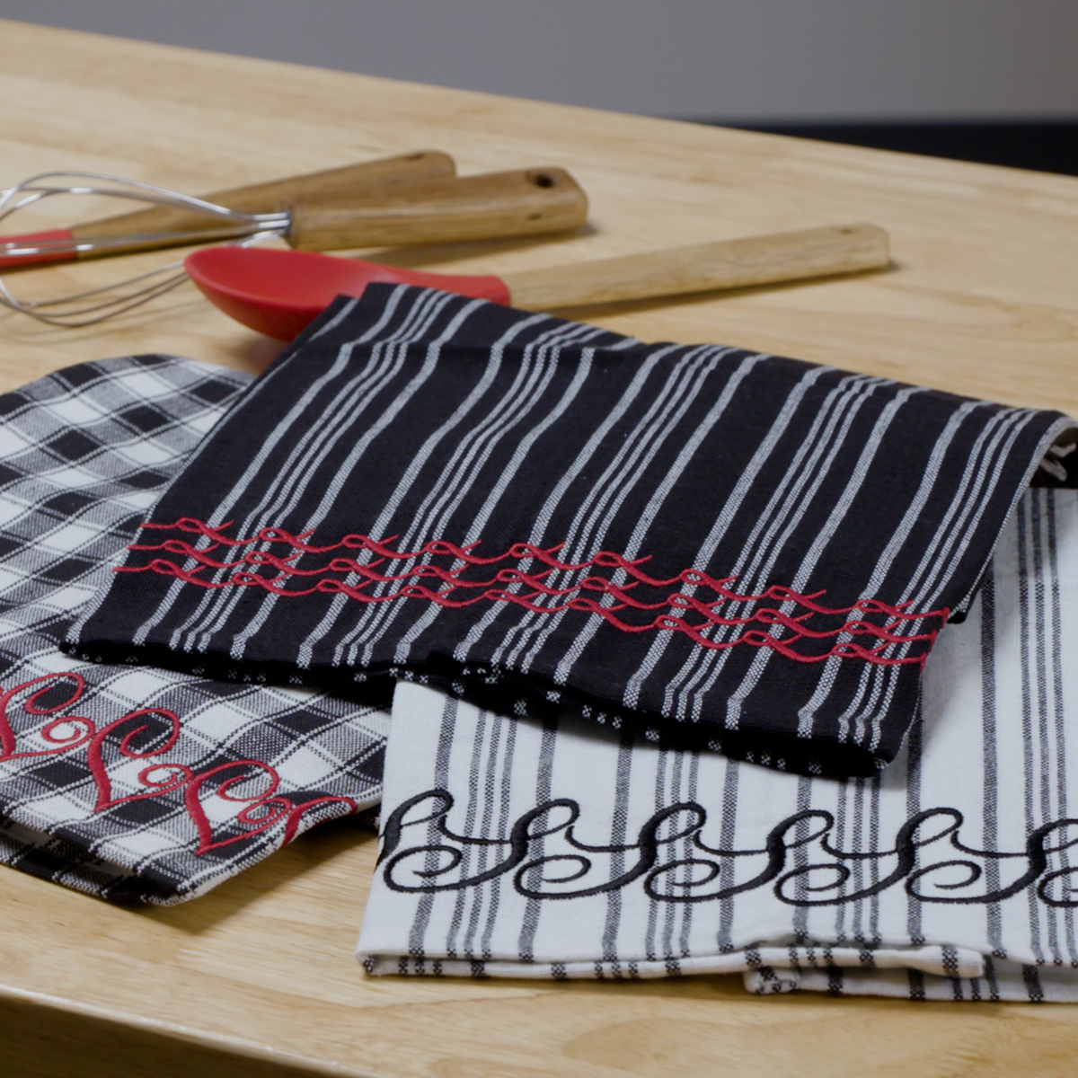 Black and white tea towels arranged on a kitchen counter