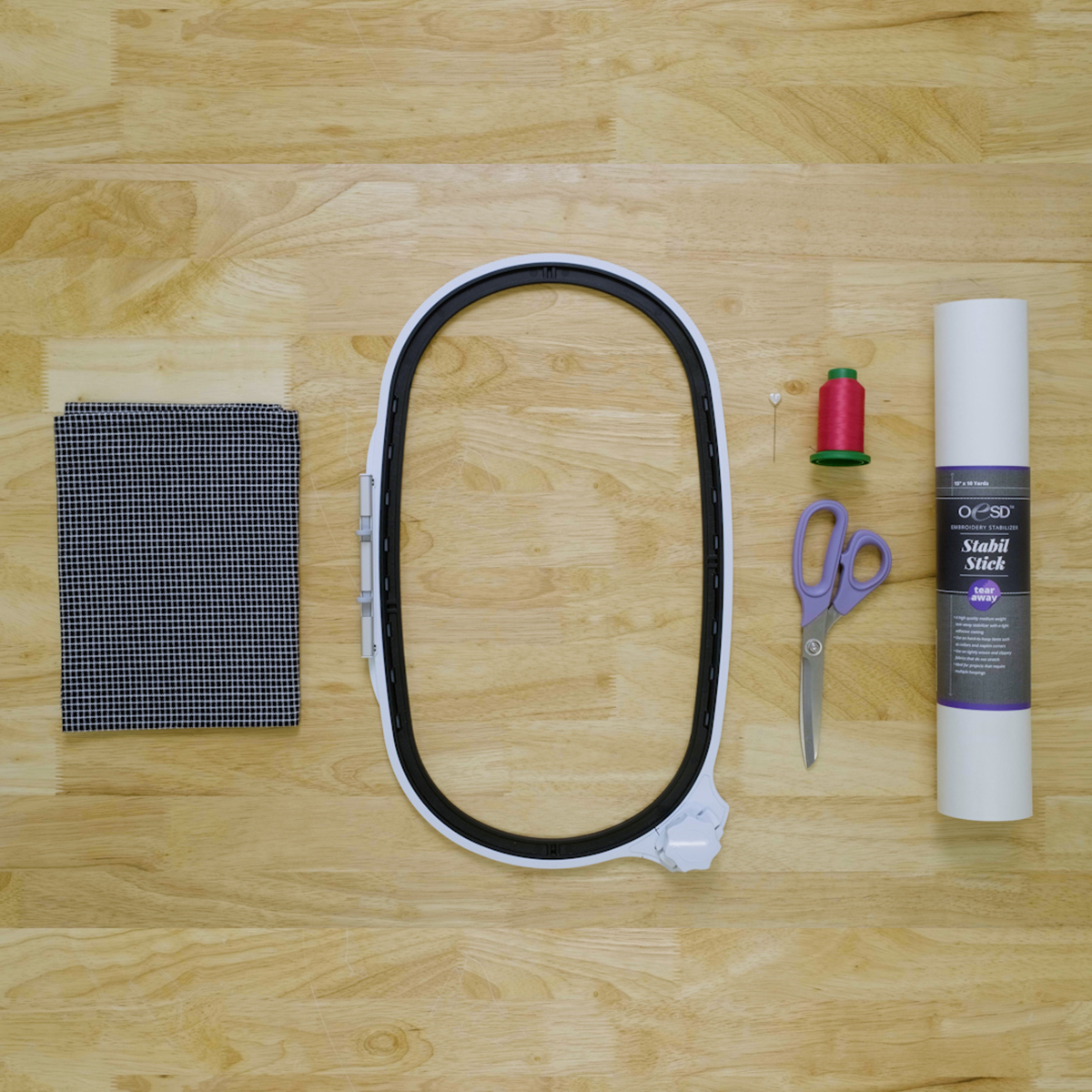 overhead view of embroidery supplies needed to embroider a tea towel