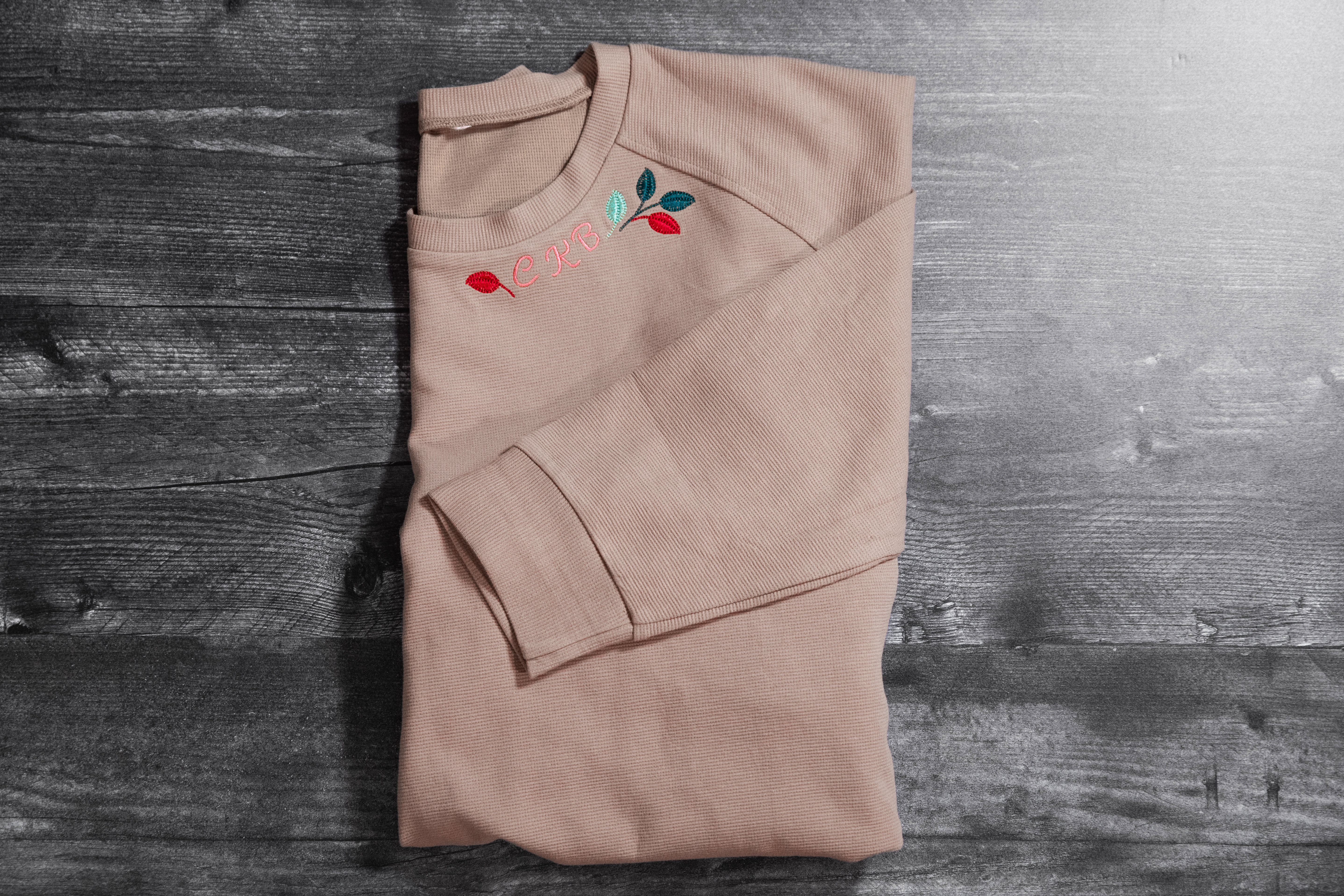 Folded embroidered sweatshirt neckline