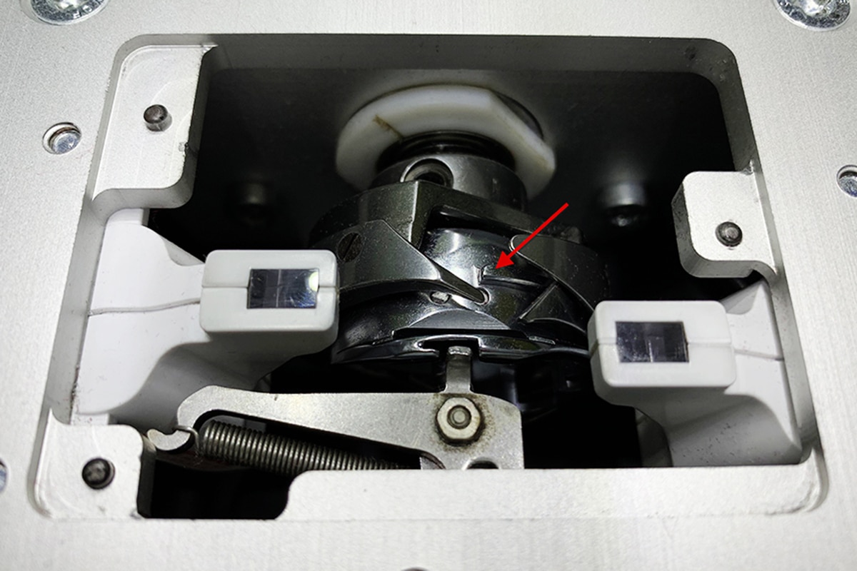 Oil dropped on metal piece in bobbin area