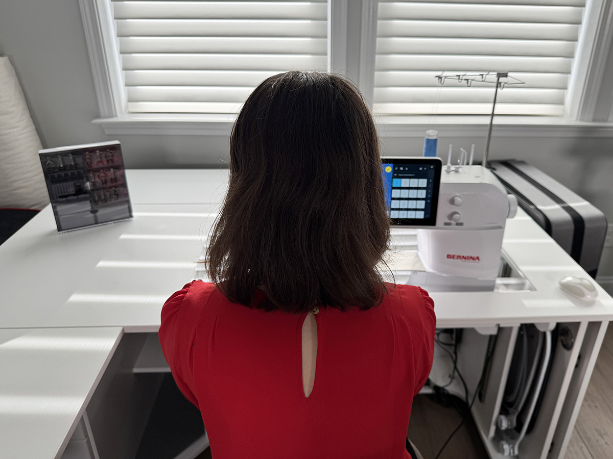 Amanda sitting in front of cabinet