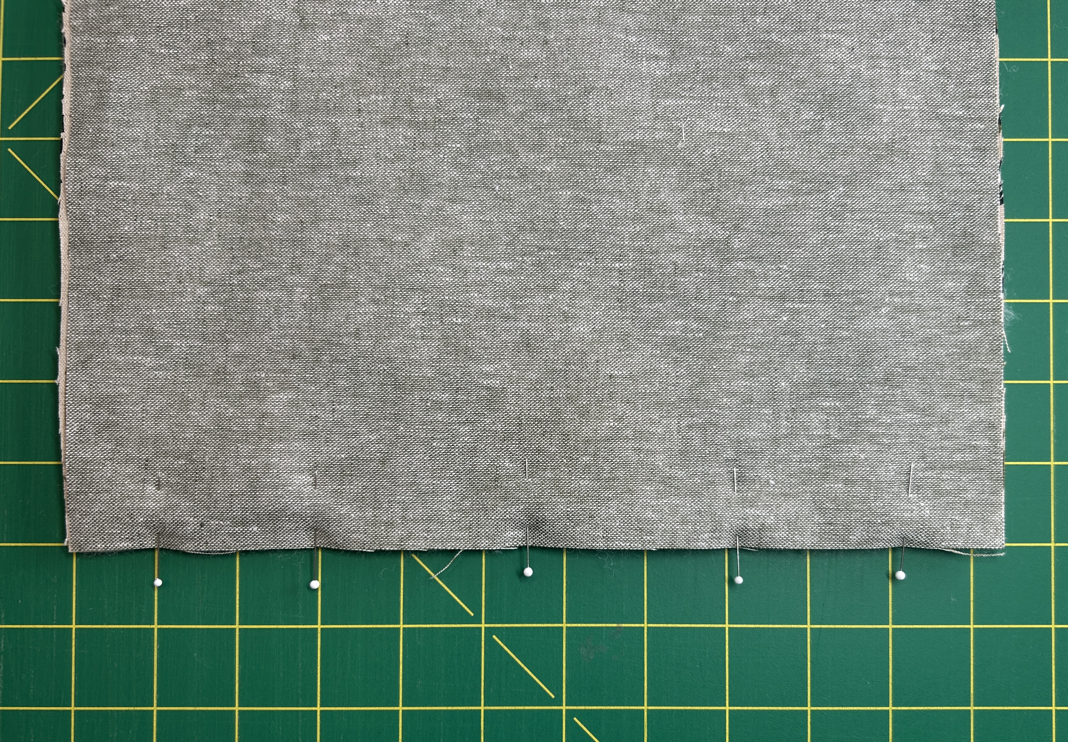 lining fabric pinned on top of main fabric