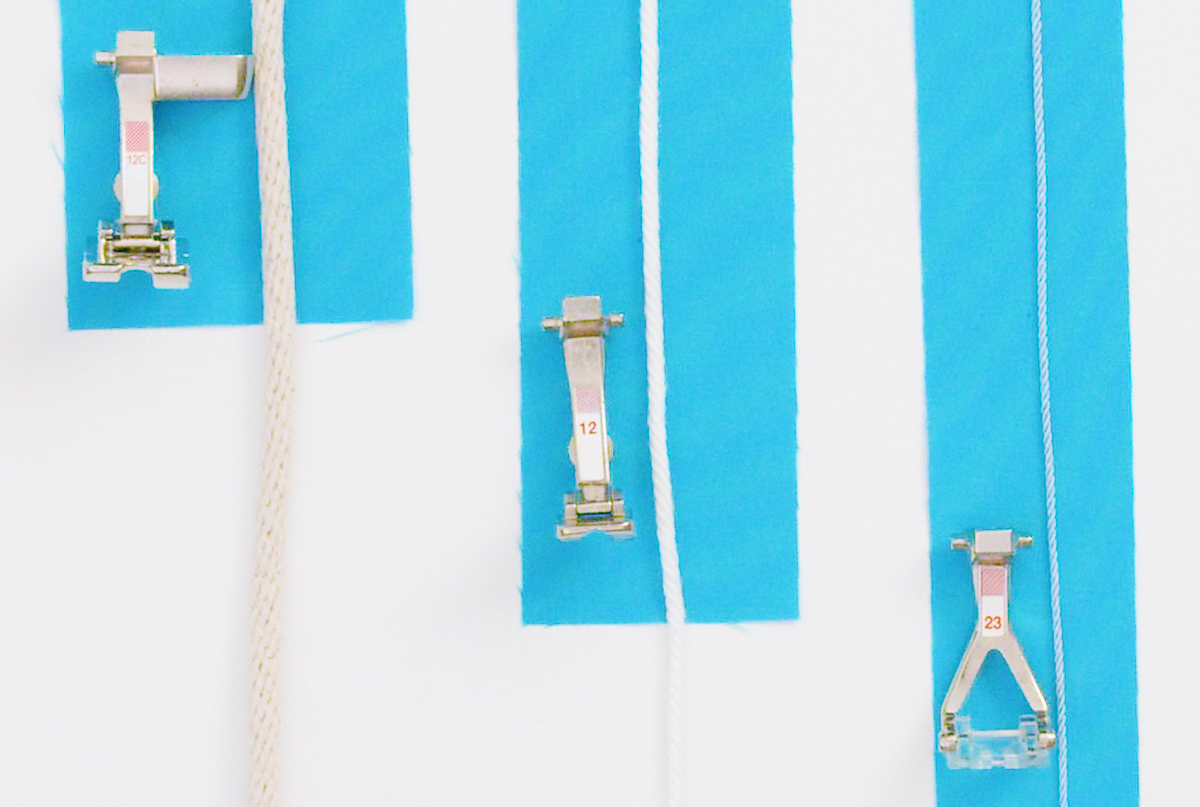 Blue fabric with various sizes of cording and presser feet